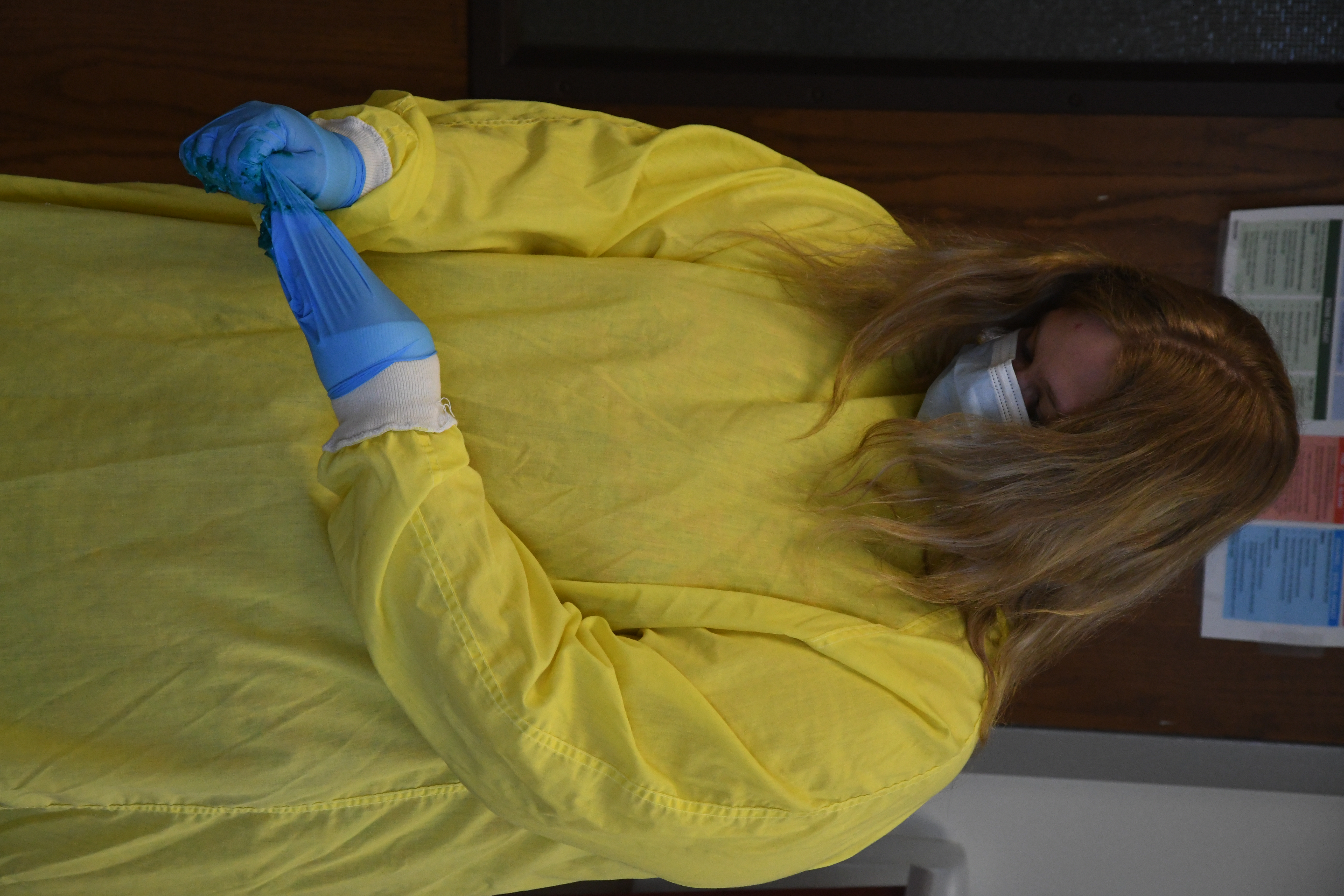 Student taking off protective gear