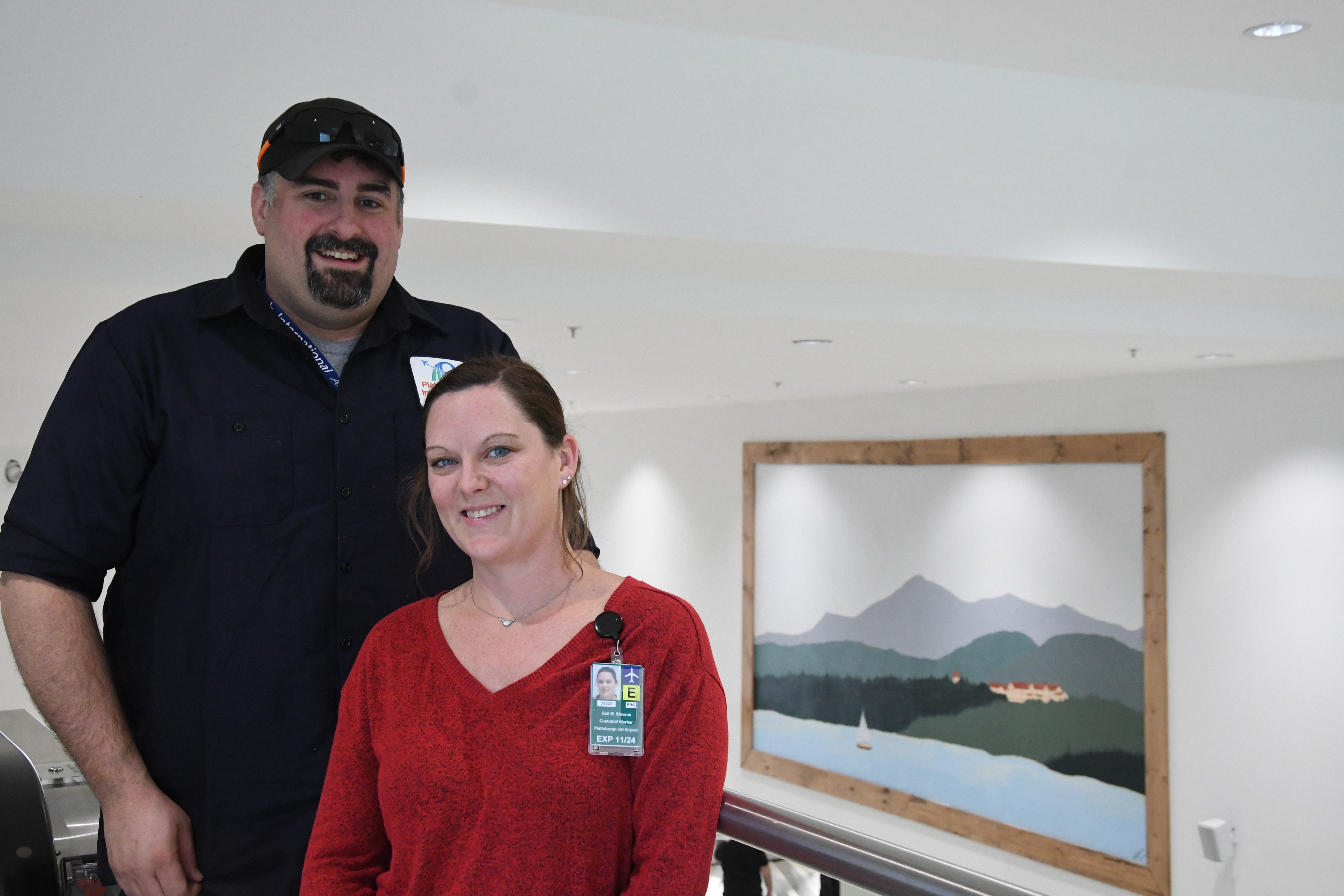 Gail and Eric posing in front of the new mural at the airport.