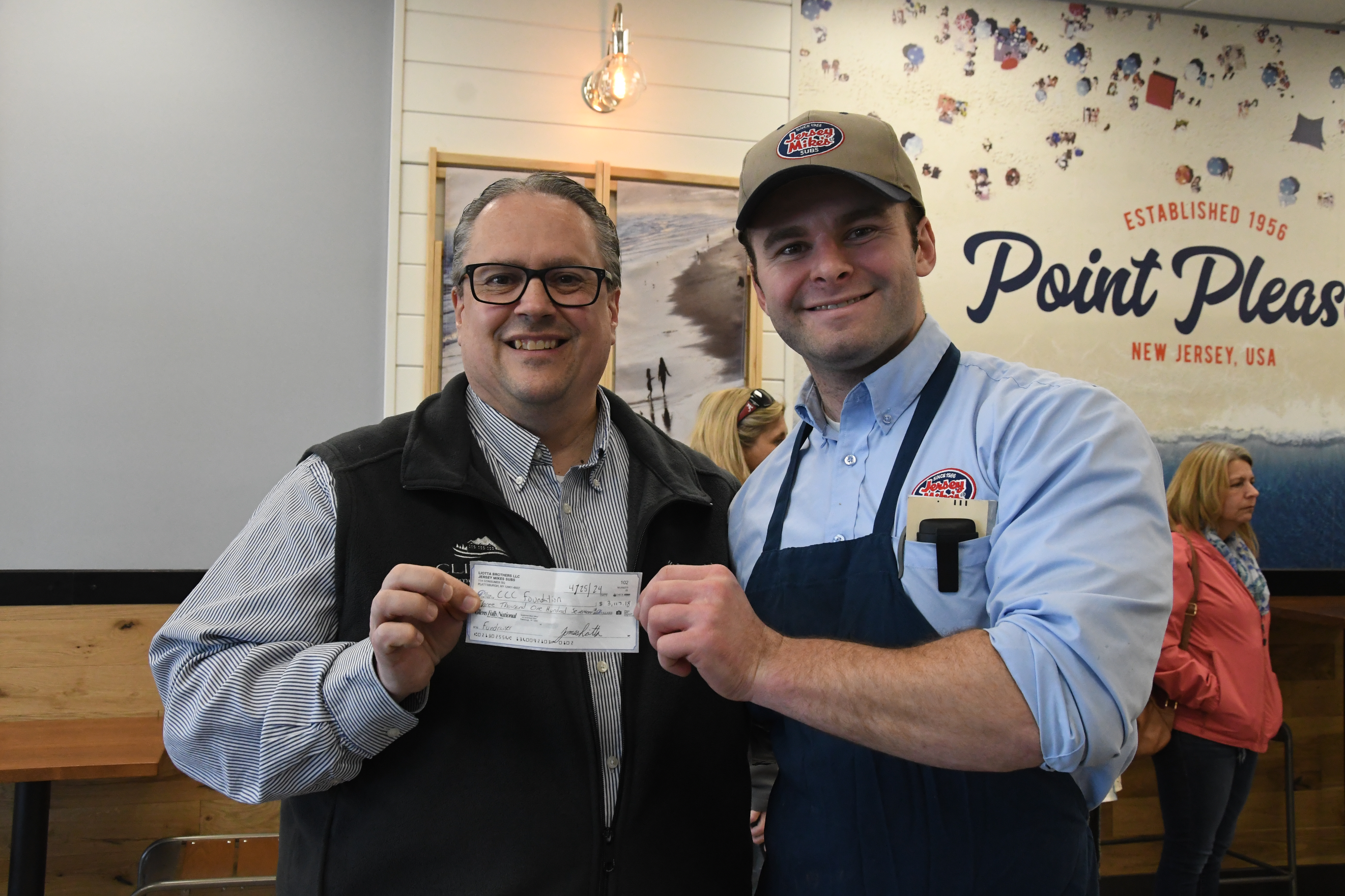 Steve Frederick and one of the owners of Jersey Mike's posing with the check.