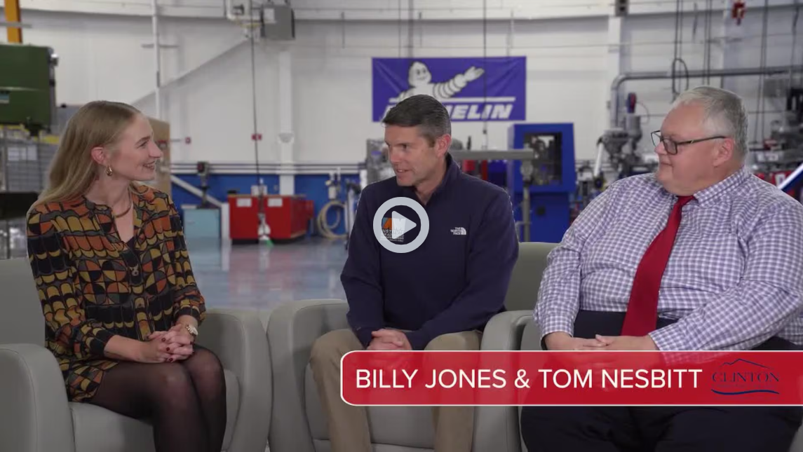 Three people sitting in chairs in a metalworking shop with text that says 'Billy Jones & Tom Nesbitt, Clinton Community College'