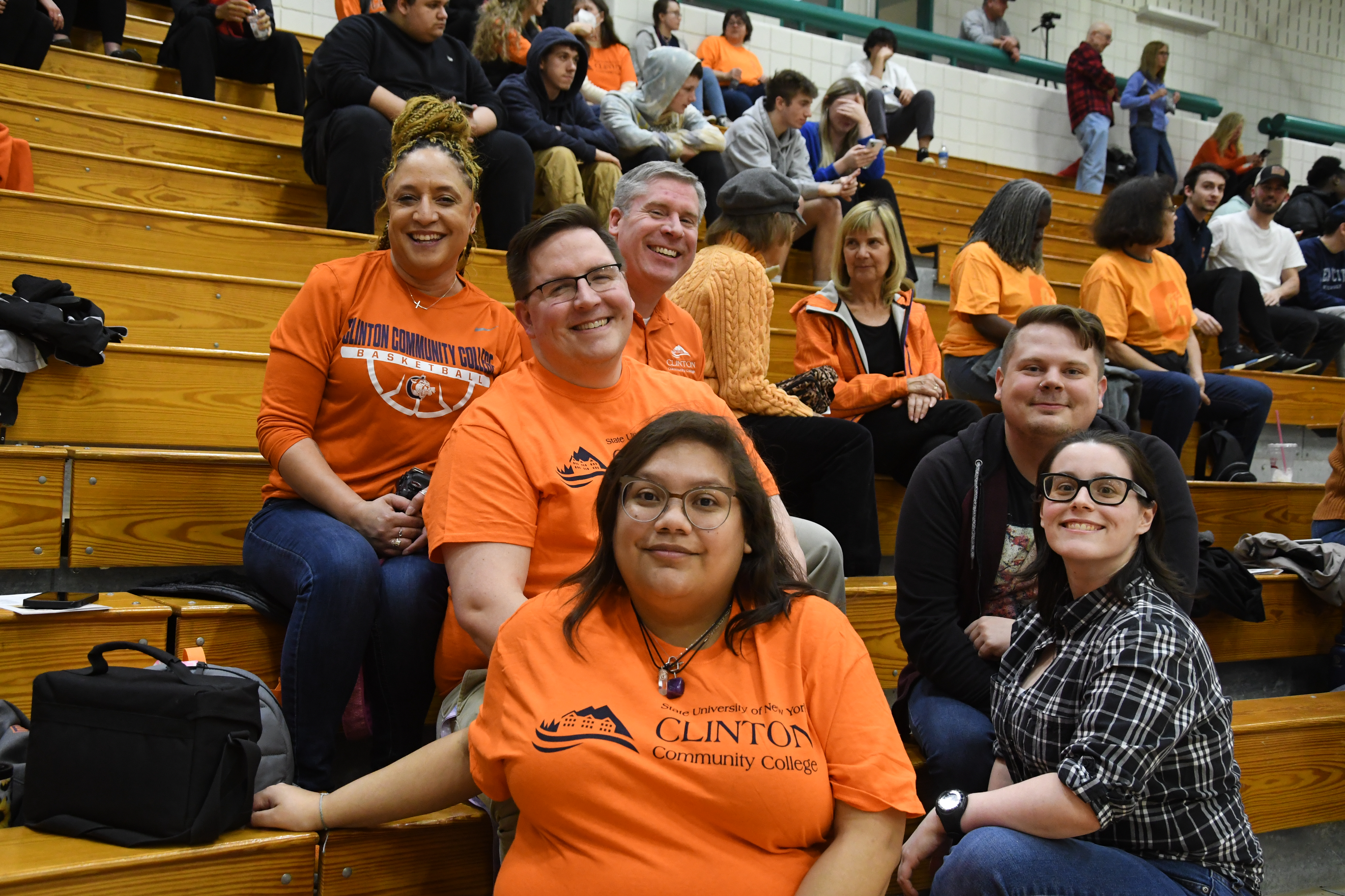 bball fans smiling in the stands